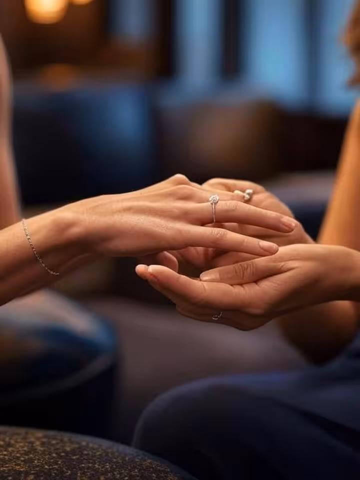 Close-up of elegant hands with subtle jewelry during meaningful conversation, refined posture, soft
