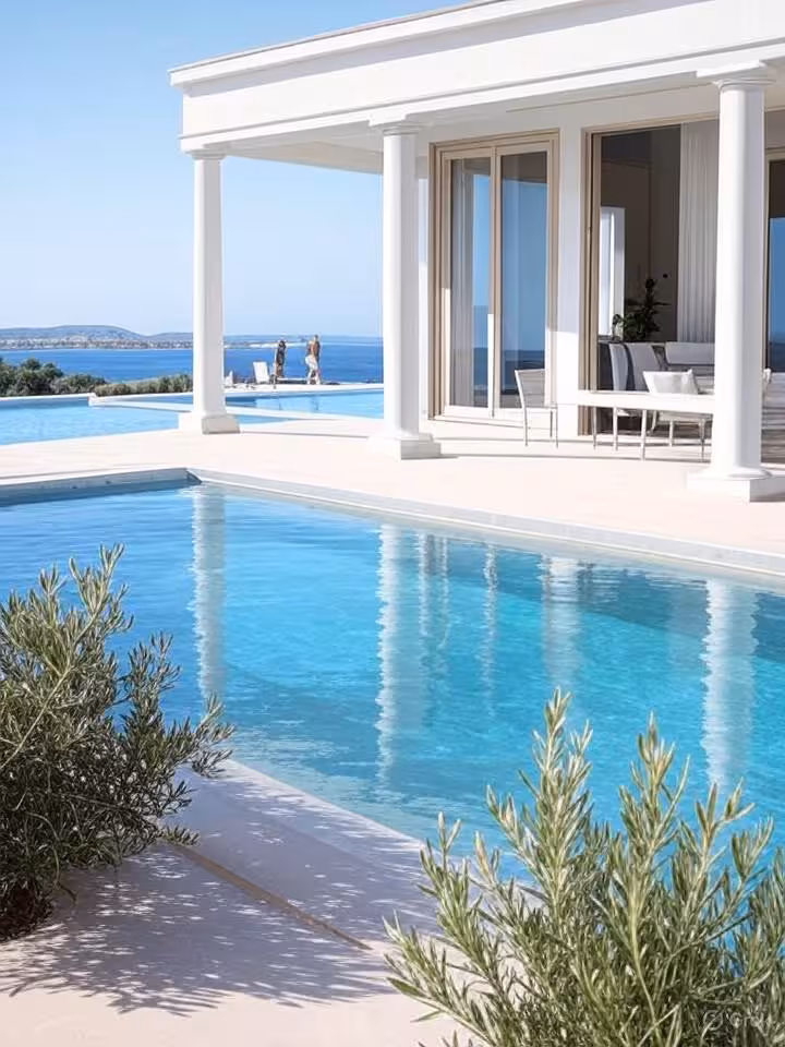 Greek Cycladic-style luxury villa with white columns and infinity pool, Aegean Sea views, olive grov