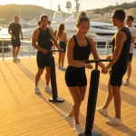 Elegant fitness scene in luxury yacht club, morning golden light, sophisticated people in athletic w